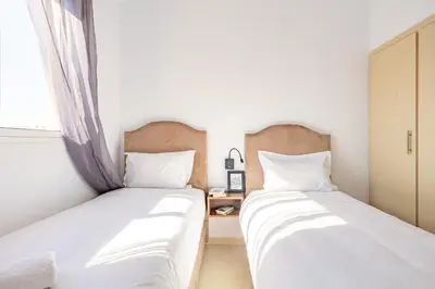 two beds sitting next to each other in a bedroom at Marrakech kamed home in Marrakech