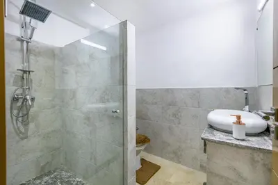 a bathroom with a shower and a sink at Élégant Appartement , Terrasse in Marrakech