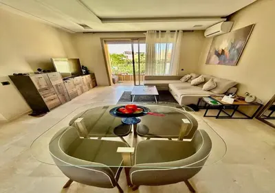 a living room with a glass table and a couch at Havre de Paix Piscine Lagon & parc in Marrakech
