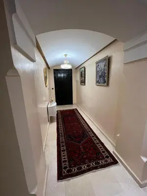 a hallway with a black door and a red rug at Luxury apartment 3 in the heart of Gueliz, Wifi, Pool in Marrakech