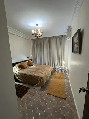 a bedroom with a bed and a table in it at Luxury apartment 3 in the heart of Gueliz, Wifi, Pool in Marrakech