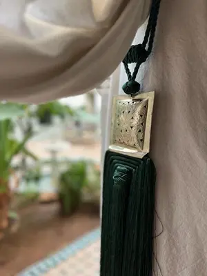 a clock hanging on the side of a wall at Riad Afous in Marrakech