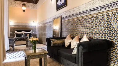a living room with a couch and a bed at Riad Afous in Marrakech