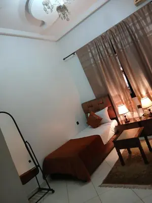 a bedroom with a bed and a desk and a mirror at Paradise house in Marrakech