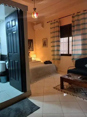 a bedroom with a bed and a door in a room at Paradise house in Marrakech