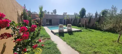 a backyard with a swimming pool and some flowers at city garden Kech in Marrakech