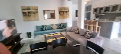 a living room with a couch and a table at city garden Kech in Marrakech