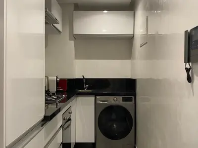 a small kitchen with a washing machine in it at Rooftop Pool, Atlas View, M avenue in Marrakech