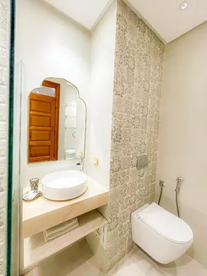 a white bathroom with a sink and a toilet at Au cœur de la palmeraie de Marrakech in Marrakech