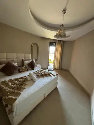 a bedroom with a large bed and a window at Appartement neuf climatisé, centre Marrakech. in Marrakech