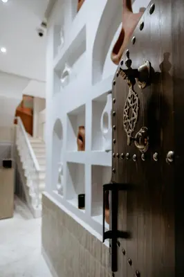 a wooden door with a lock on it in a room at Riad K-white in Marrakech