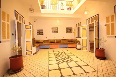a living room with a couch in the middle at El Boussouni Hostel in Marrakech