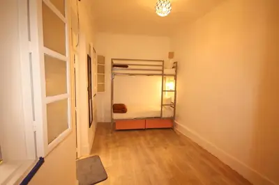 a hallway with a bedroom with a bunk bed in it at El Boussouni Hostel in Marrakech