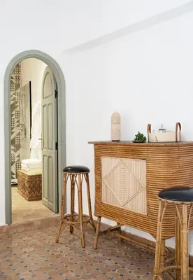a room with two stools and a table and a mirror at Riad Al Uzza in Marrakech