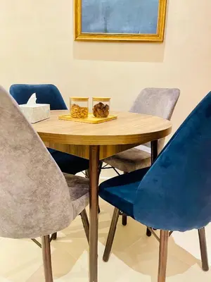 a wooden table with four blue chairs around it at Stay In Marrakech Blue Appartment in Marrakech