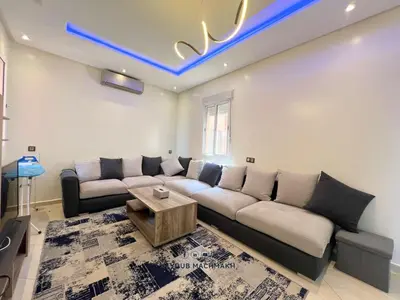 a living room with a couch and a table at Lucky Nest apartment À Bassatine targa Marrakech à proximité de Hammam Zinaya in Marrakech