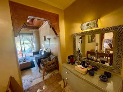 a living room with a mirror on the wall at Les Fleurs du Bien - Marrakech in Marrakech