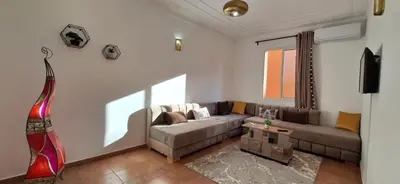 a living room with a couch and a table at Escale Marrakech in Marrakech