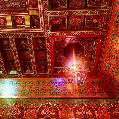 a chandelier hanging from the ceiling of a room at Riad Kamal prés Medina Marrakech & 3 Piscines & Jacuzzi & Petit-Déjeuner in Marrakech
