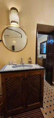 a bathroom with a sink and a mirror at Riad Dar Si Driss in Marrakech