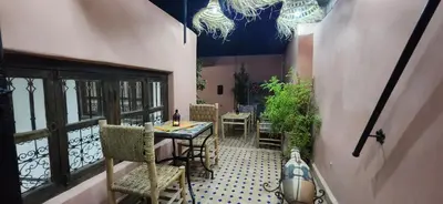 a patio with a table and chairs in a building at Riad Dar Si Driss in Marrakech