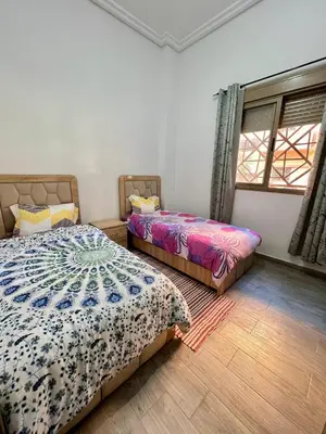a bedroom with two beds and a window at MyZo Superbe Appartement familial bien situé à Marrakech in Marrakech