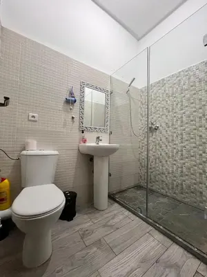 a bathroom with a toilet and a sink and a shower at MyZo Superbe Appartement familial bien situé à Marrakech in Marrakech