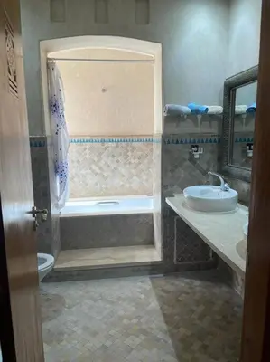 a bathroom with a shower and a toilet and a sink at Merveilleuse Marrakech! in Marrakech