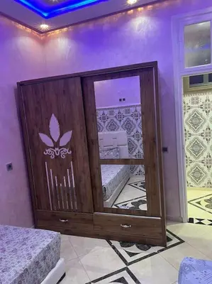 a bedroom with a mirror in a purple room at Redone in Marrakech