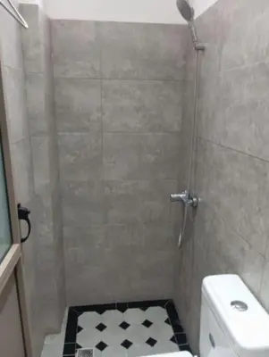 a bathroom with a shower with a toilet and a sink at Redone in Marrakech