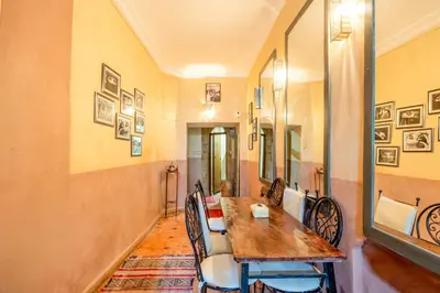 a dining room with a wooden table and chairs at Little Riad 3 Rooms - Top emplacement 5 minuts from Place Jemaa el fna & souk in Marrakech