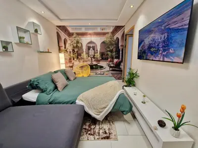 a living room with a couch and a large painting at Marrakeschzentrum Hideaway in Marrakech