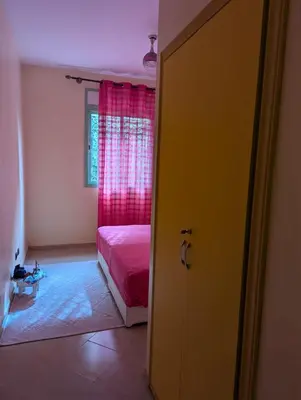 a bedroom with a pink bed and a window at Angel Appartement in Marrakech