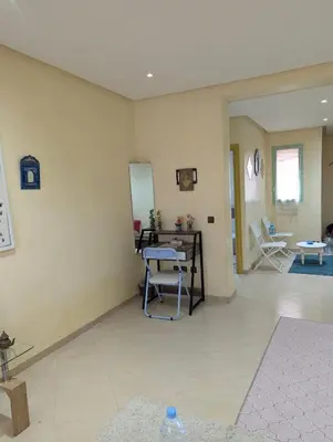 a room with a table and chairs and a mirror at Angel Appartement in Marrakech
