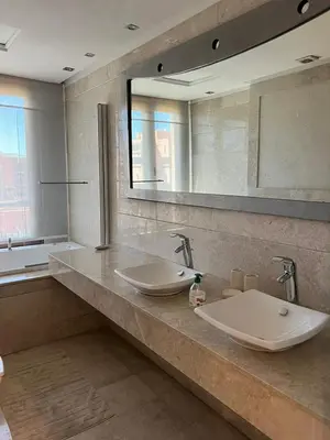 a bathroom with two sinks and a large mirror at Superbe appartement de luxe a l'hivernage marrakech in Marrakech