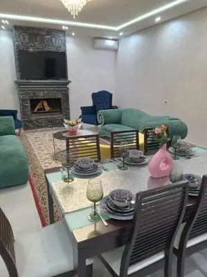 a living room with a table and a fireplace at Private Villa with private Chef optional in Marrakech