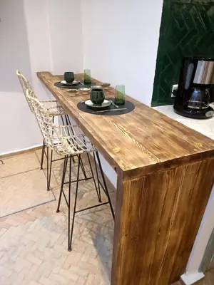 a wooden table with two chairs and a television on it at Riad KaBaYa Charme Exclusif Privatisé 2 à 8 Pers. in Marrakech