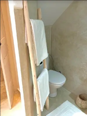 a bathroom with a toilet and towels on a ladder at Riad KaBaYa Charme Exclusif Privatisé 2 à 8 Pers. in Marrakech