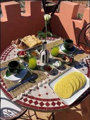 a table with a plate of food on it at Riad KaBaYa Charme Exclusif Privatisé 2 à 8 Pers. in Marrakech