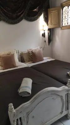 a white bed with a towel on top of it at maison noé , residence al quaria ab40 in Marrakech