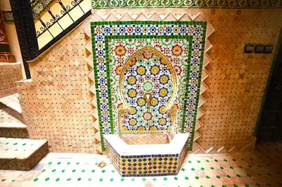 a bathroom with a mosaic wall with a sink at Riad Atlas avec jacuzzi 3 piscines au cœur de Marrakech in Marrakech