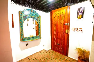 a room with a door and a mirror on the wall at Riad Atlas avec jacuzzi 3 piscines au cœur de Marrakech in Marrakech