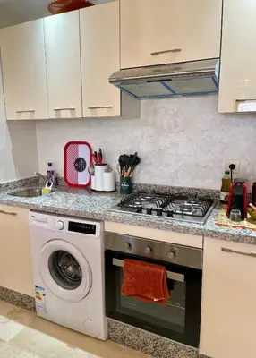 a kitchen with a stove and a washing machine at Pearl Garden Studio Cozy Panoramic Charming sunny Terrace Piscine in Marrakech