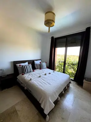 a bedroom with a large bed with a large window at Villa avec piscine chauffée & privée, 3 chambres in Sraghna