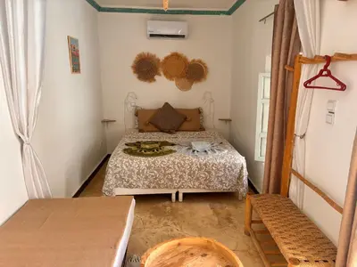 a small bedroom with a bed in a room at Riad Sanwa in Marrakech