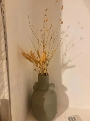 a green vase with some plants in it at Riad Sanwa in Marrakech