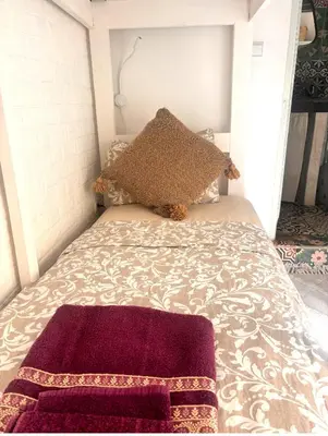 a bed with two pillows on top of it at Riad Sanwa in Marrakech