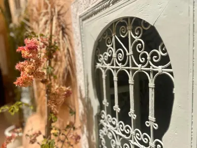 a door with a wrought iron gate on a wall at Riad Sanwa in Marrakech
