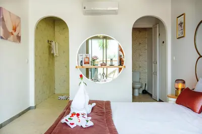 a bedroom with a bed and a mirror at Villa Serenity & SPA - Breakfast in Marrakech
