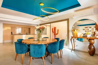 a dining room with a wooden table and blue chairs at Villa Serenity & SPA - Breakfast in Marrakech